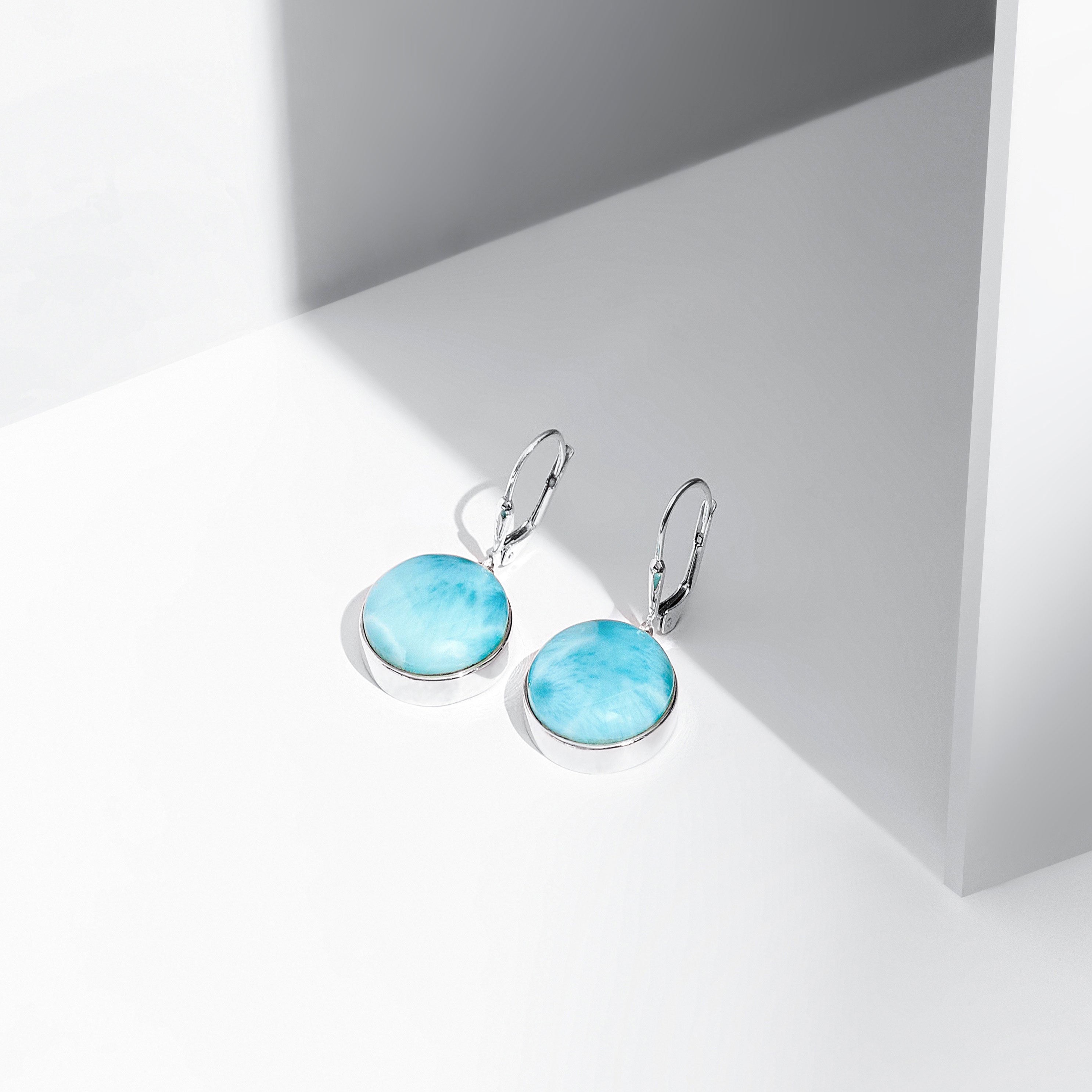 Round shaped Larimar earrings made in the Dominican Republic.