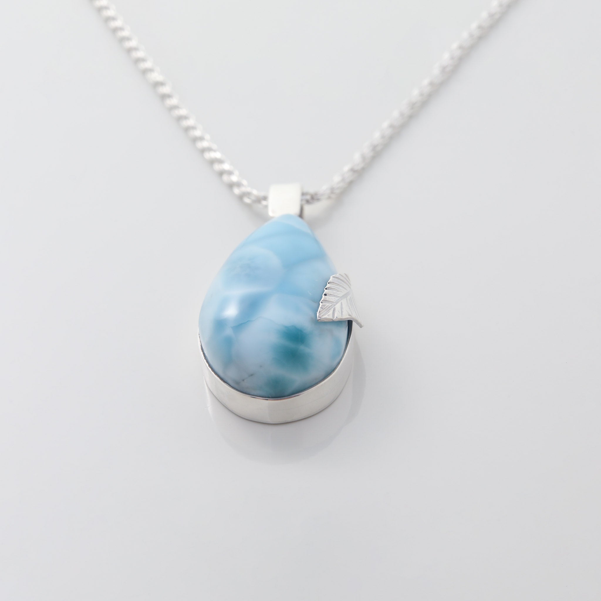 Larimar Pendant Flora complemented by a delicate silver leaf detail