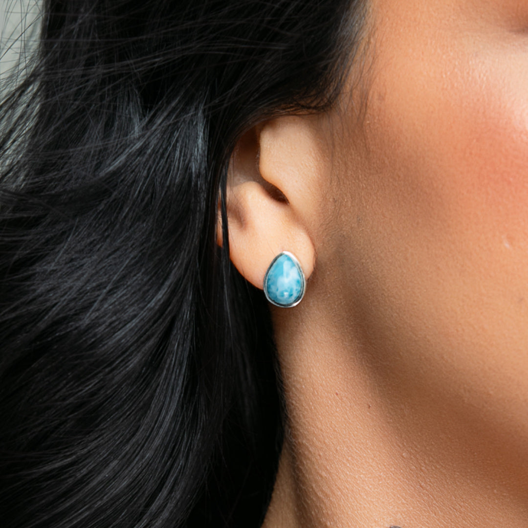 Women wearing blue Larimar studs in pear-shape in a silver metal style.