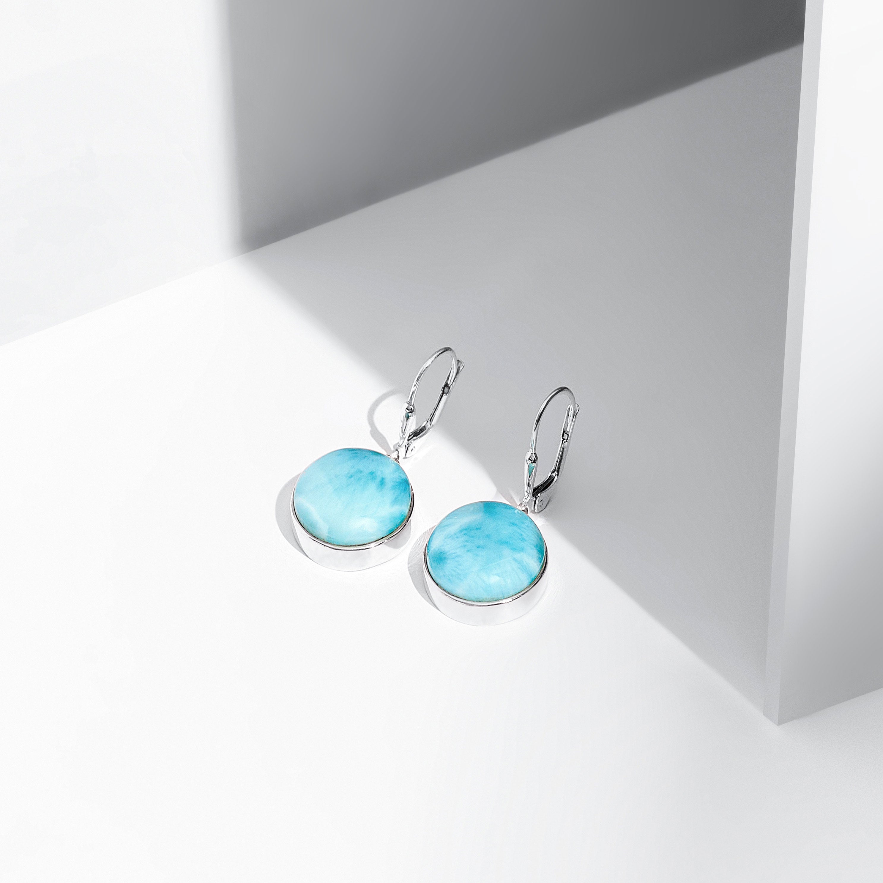 Round shaped Larimar earrings made in the Dominican Republic.