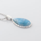 The Larimar Pendant Rhea showcases a Larimar stone with unique geometric edges