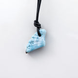 This unique necklace features a wing-shaped larimar stone on a leather cord