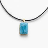 Larimar Necklace with a blue pendant on a white background