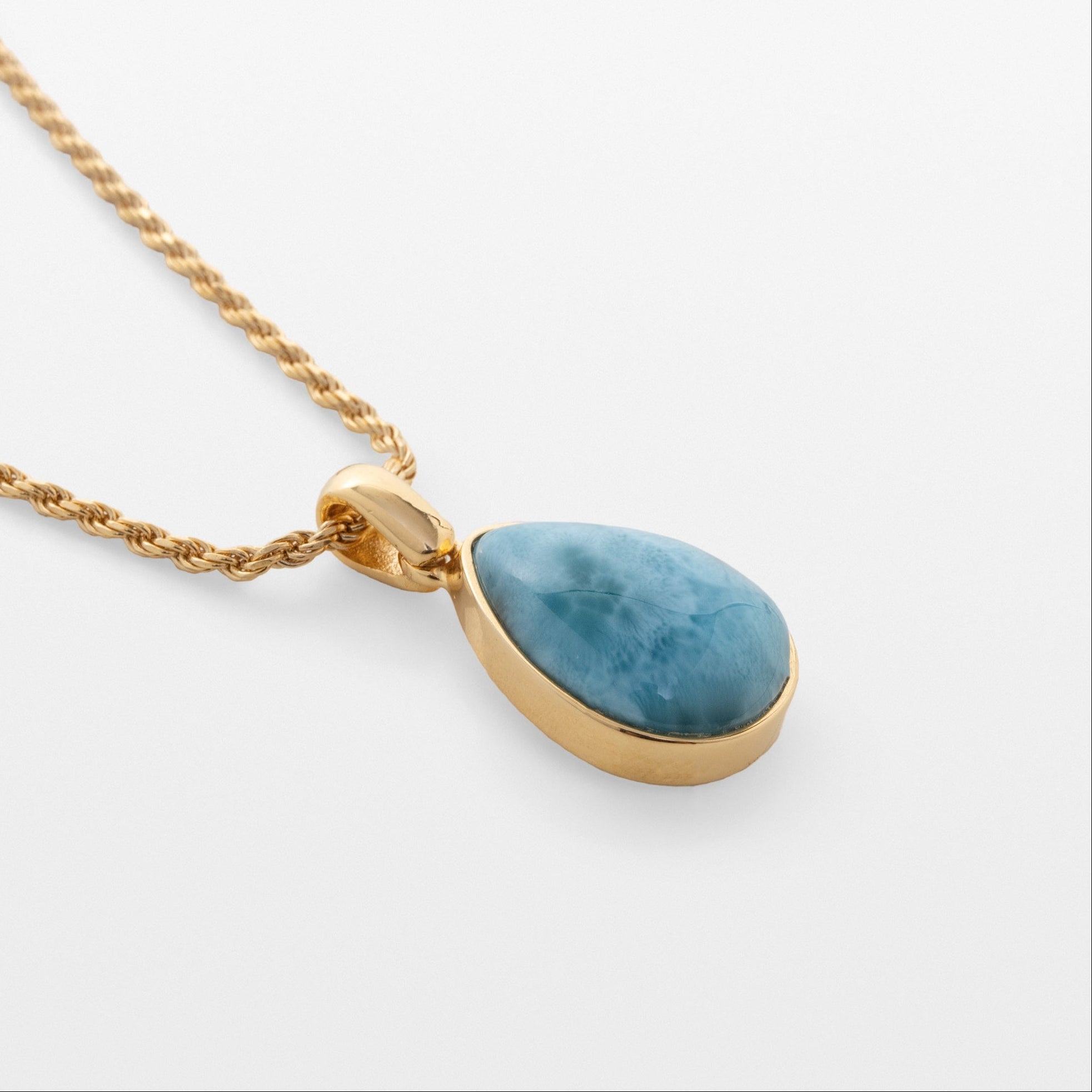 Larimar Gold necklace with a blue teardrop pendant on a white background