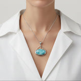 Larimar Pendant Willa pendant necklace on a white shirt against a neutral background