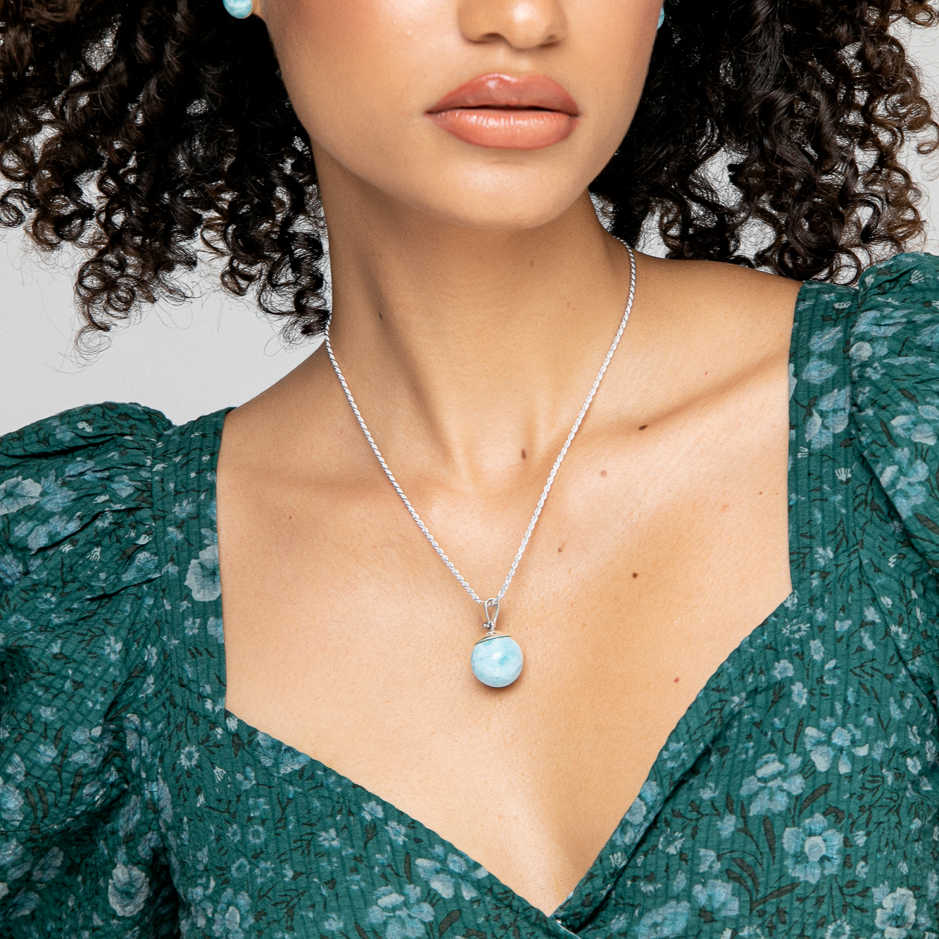 Experience the timeless elegance of the Cecile round Larimar bead pendant. The mesmerizing blue hues of the Larimar stone are showcased by the sleek silver setting, creating a stunning piece that never goes out of style. Handcrafted with care and attention to detail, this pendant is a must-have accessory that's perfect for any occasion. Elevate your look with the understated sophistication of the Cecile pendant, and showcase the natural beauty and timeless charm of the round Larimar bead