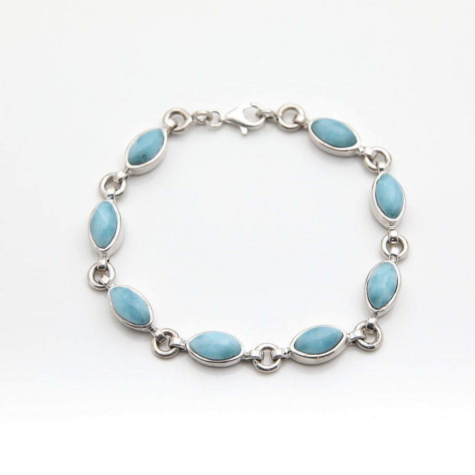 Silver Larimar bracelet with blue stones on a white background