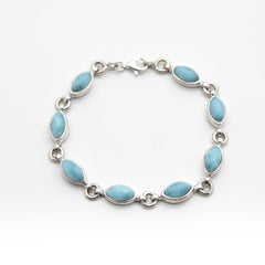 Silver Larimar bracelet with blue stones on a white background